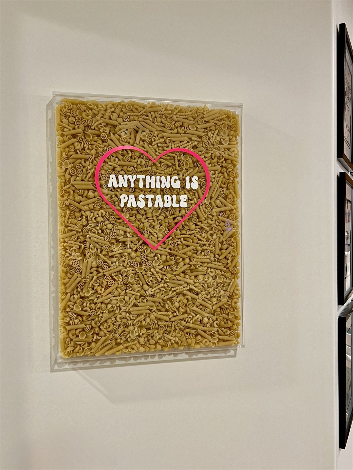 Large pasta wall art reading Anything Is Pastable